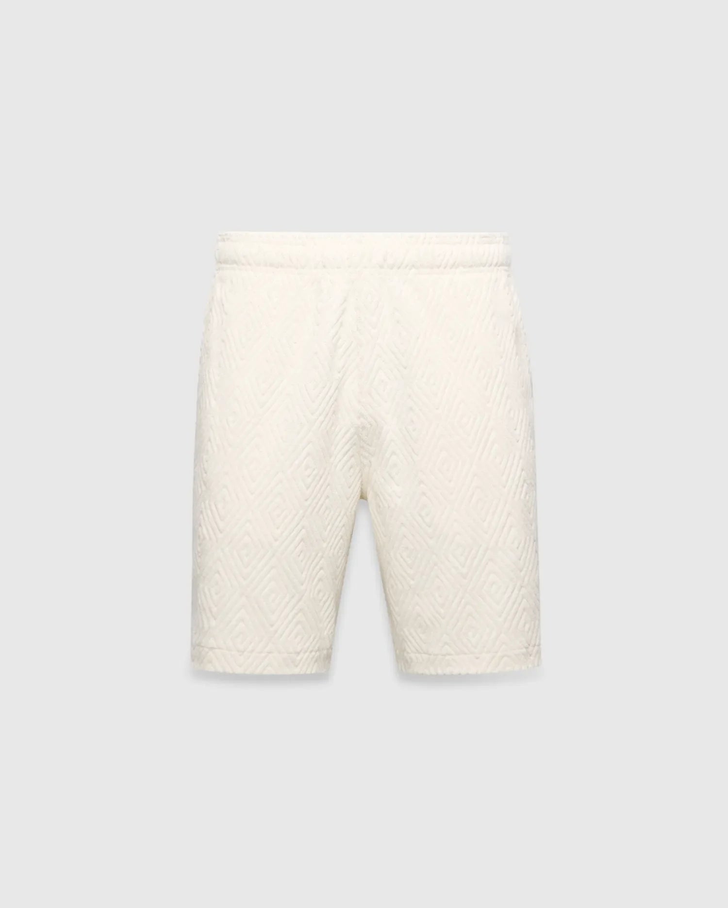 Mens Tristan Short in cream, a relaxed fit short with an all-over raised geometric concentric square pattern on textured fabric, no visible Psycho Bunny logo.
