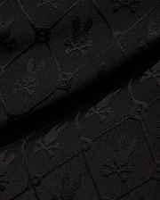 Mens Garry Jacquard Sweatshort in black, featuring a tonal all-over jacquard knit pattern of the iconic Psycho Bunny skull logo and PB initials.