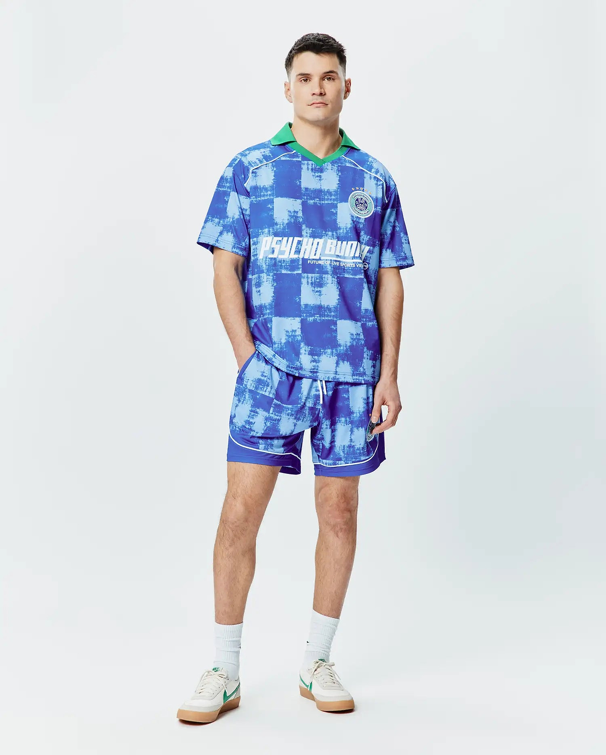 Psycho Bunny blue distressed checkerboard jersey polo with green collar, large chest logo, and matching Mens Micah Soccer Short 6 3/4 with white piping and small bunny skull logo. (4)
