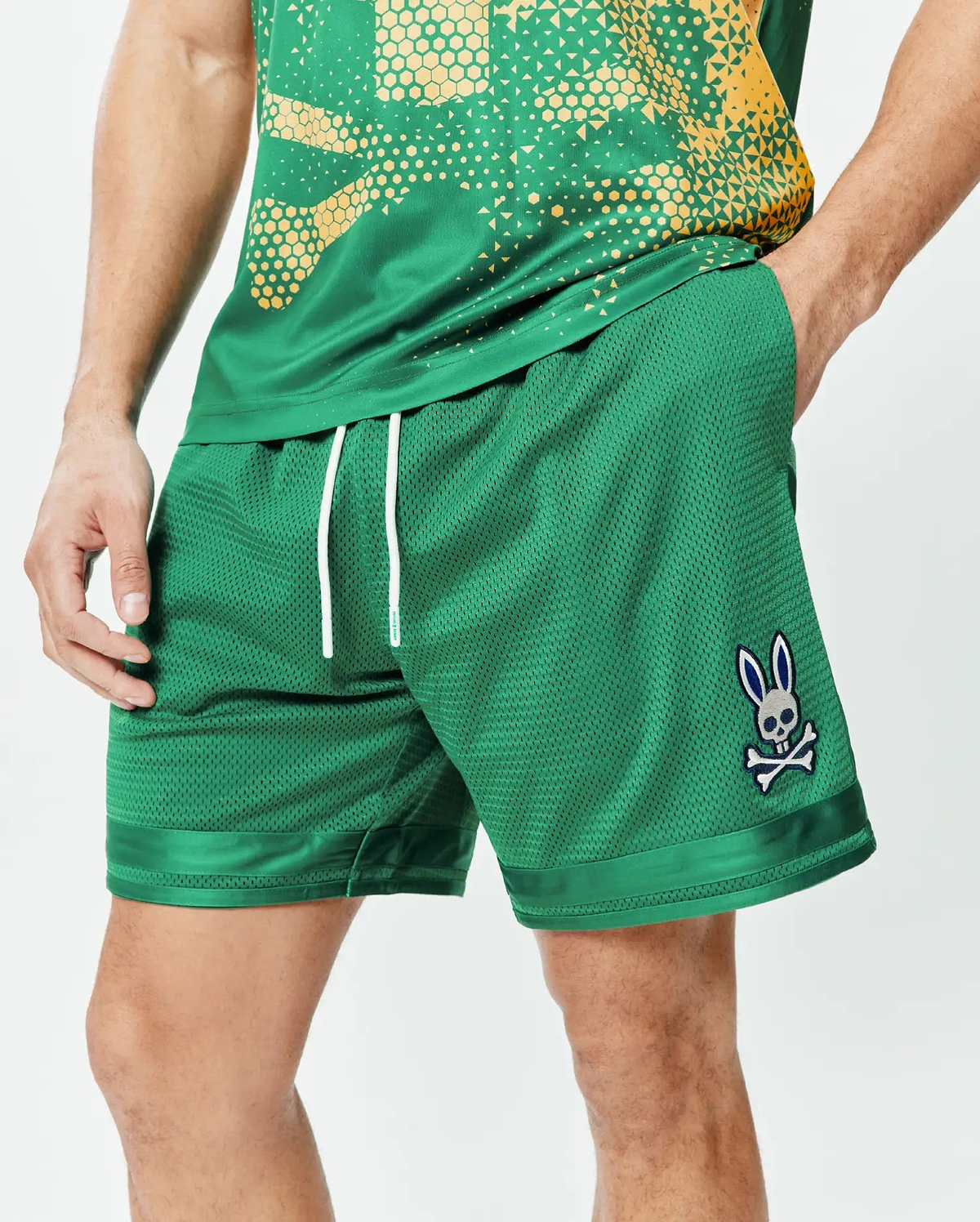 Mens Joshua Soccer Short 7 1/4, emerald green breathable mesh, relaxed fit with white drawstrings and satin hem trim, featuring an embroidered Psycho Bunny skull logo on the left leg. (1)