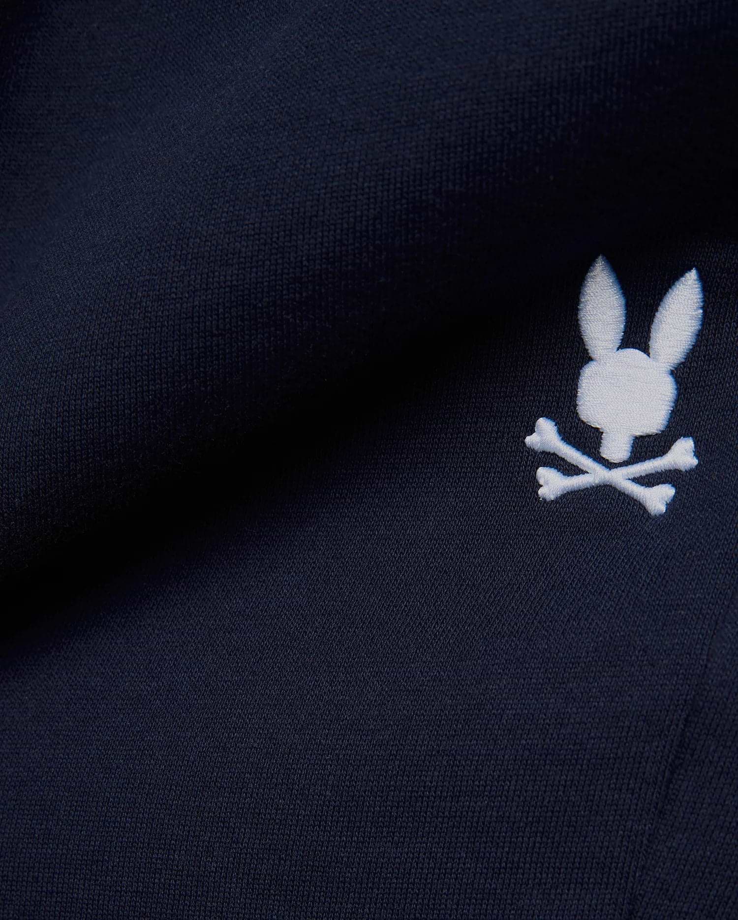 Premium deep navy blue MENS GABE FRENCH TERRY SWEATSHORT, showcasing a soft French terry knit texture and an iconic, crisp white embroidered Psycho Bunny skull logo, embodying refined streetwear style. (7)
