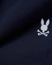 Premium deep navy blue MENS GABE FRENCH TERRY SWEATSHORT, showcasing a soft French terry knit texture and an iconic, crisp white embroidered Psycho Bunny skull logo, embodying refined streetwear style. (7)