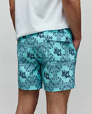 Mens Luke Swim Trunk in aqua with a dark blue all-over bandana paisley print featuring repeated Psycho Bunny skull logos, a classic fit, smooth quick-dry fabric, side pockets, and a back flap pocket.