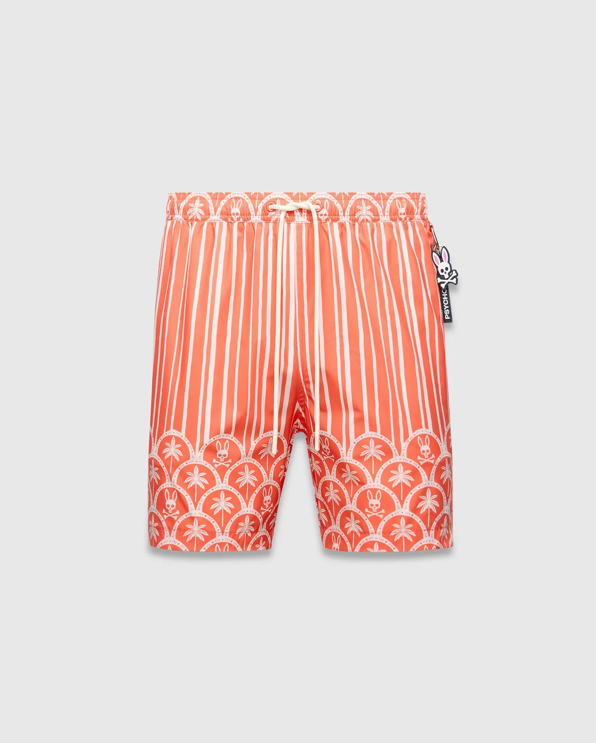 Mens Brad Swim Trunk in vibrant orange with white vertical stripes, transitioning to a scalloped border featuring white palm trees and small Psycho Bunny skull logos, smooth fabric, relaxed fit.