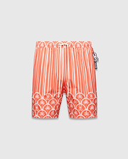 Mens Brad Swim Trunk in vibrant orange with white vertical stripes, transitioning to a scalloped border featuring white palm trees and small Psycho Bunny skull logos, smooth fabric, relaxed fit.