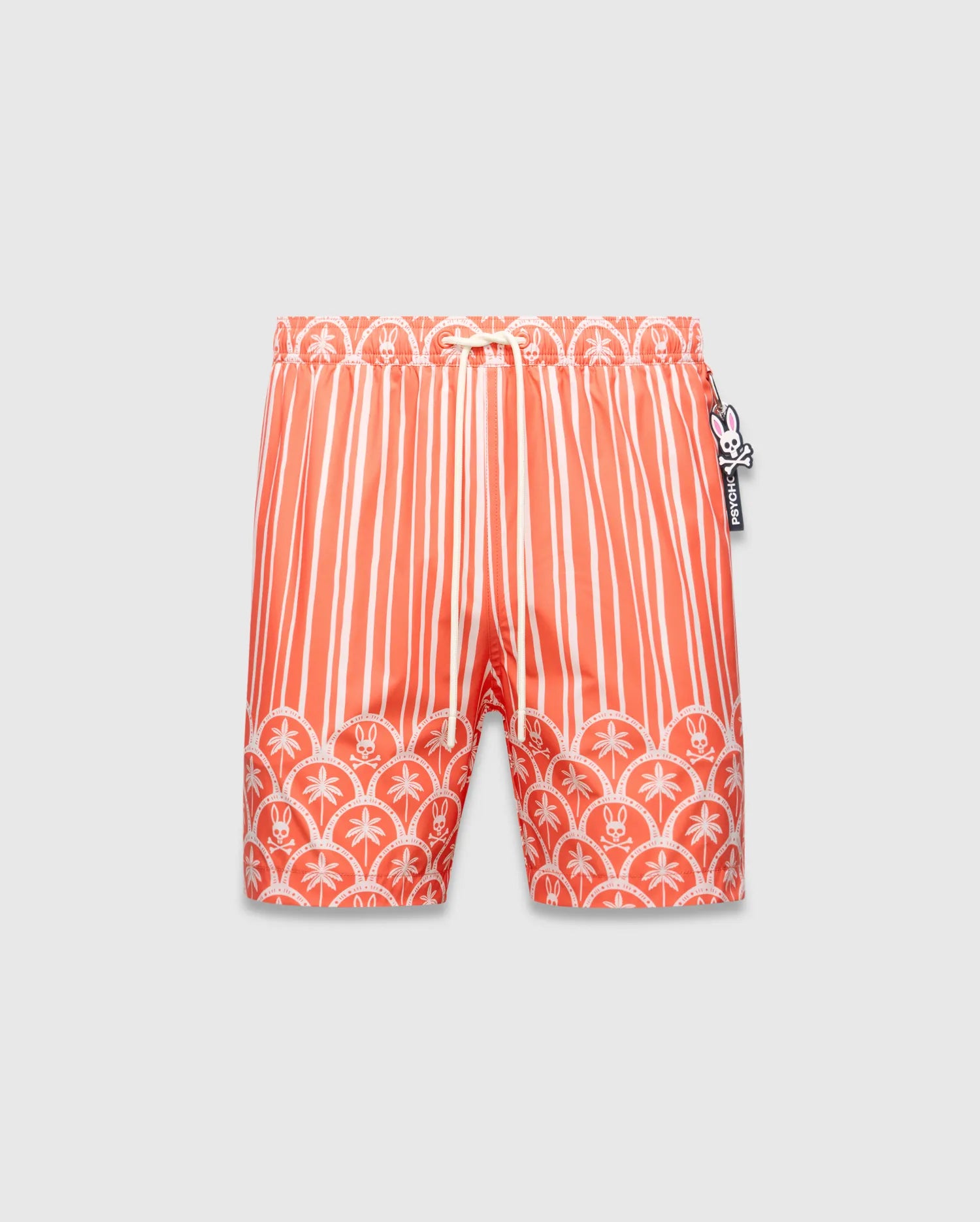 Mens Brad Swim Trunk in vibrant orange with white vertical stripes, transitioning to a scalloped border featuring white palm trees and small Psycho Bunny skull logos, smooth fabric, relaxed fit.