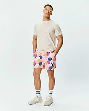 Mens Ethan Swim Trunk 6 with a multi-color abstract geometric pattern, featuring a black Psycho Bunny skull logo. Paired with a classic fit beige jersey tee with a white Psycho Bunny skull logo. (4)