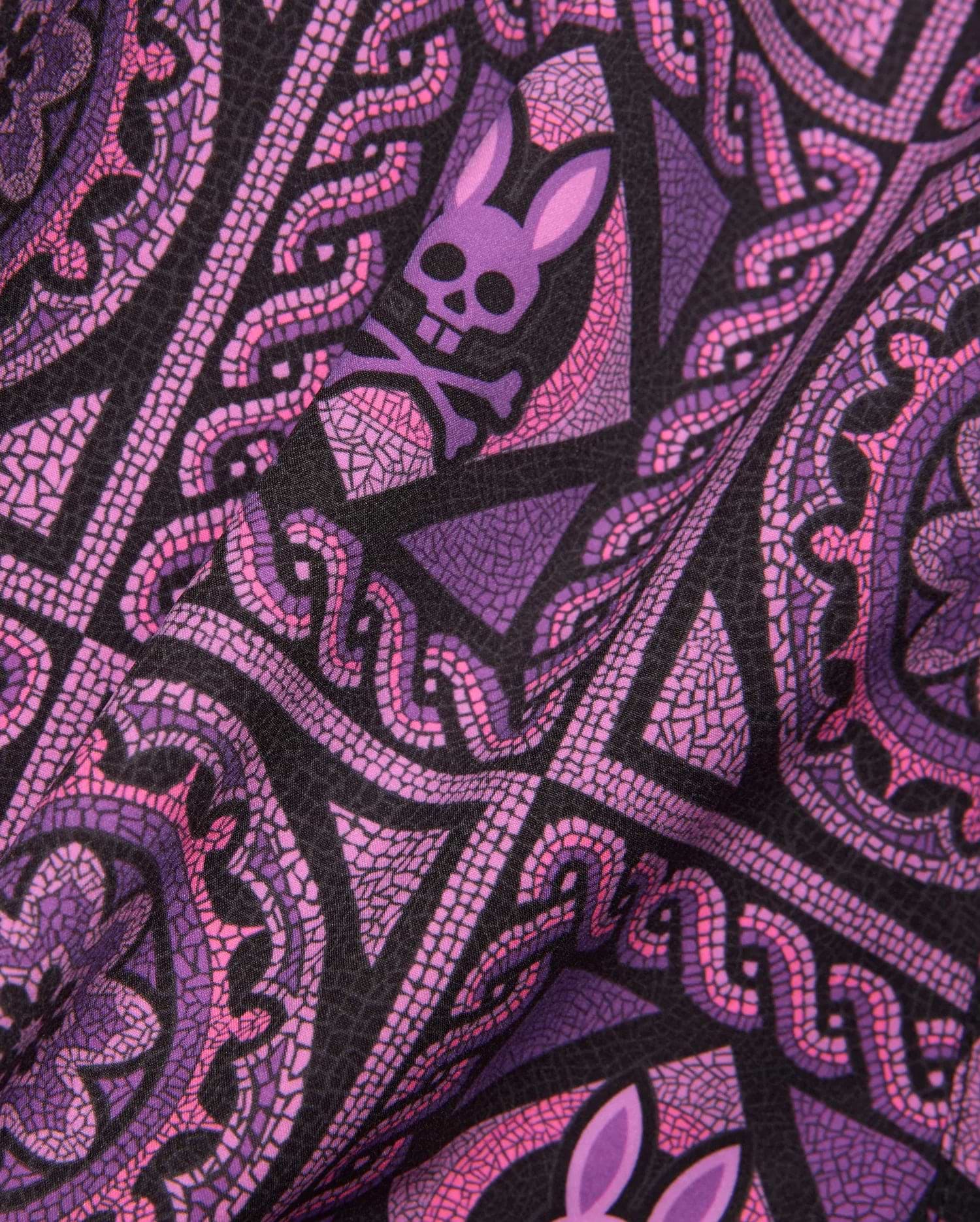 Mens Frank Swim Trunk 6 with a vibrant black, purple, and pink mosaic-style all-over print featuring repeated Psycho Bunny skull logos and intricate swirling patterns.