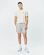 Cream jersey t-shirt with a blue and orange Psycho Bunny logo on the chest, paired with Mens Frank Swim Trunk 6 featuring a blue and orange geometric tile print with integrated bunny skull motifs.