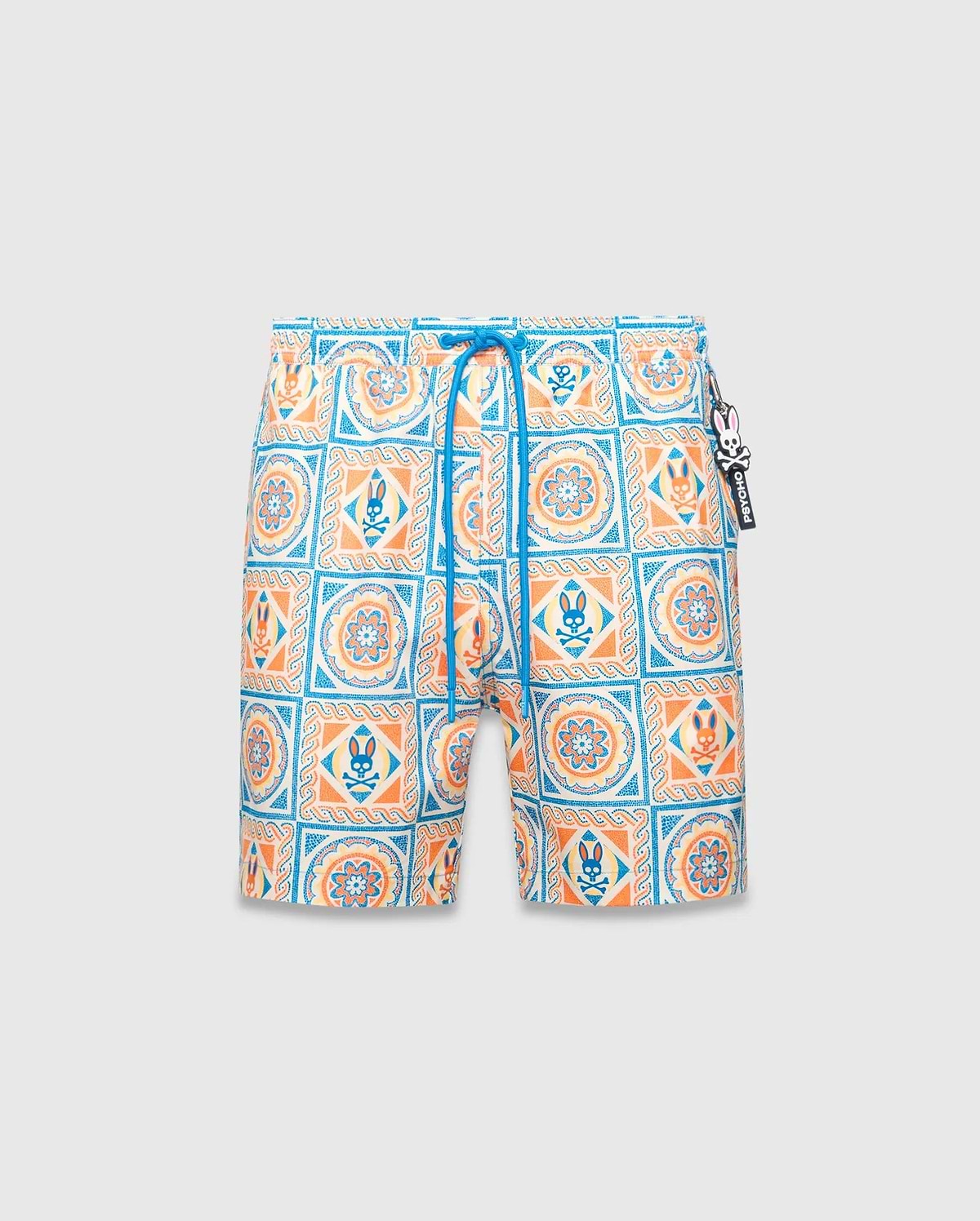 Mens Frank Swim Trunk 6, a classic fit swim trunk featuring an all-over white, blue, orange, and yellow intricate tile pattern with floral motifs and small Psycho Bunny skull logos, finished with a blue drawstring and logo charm.