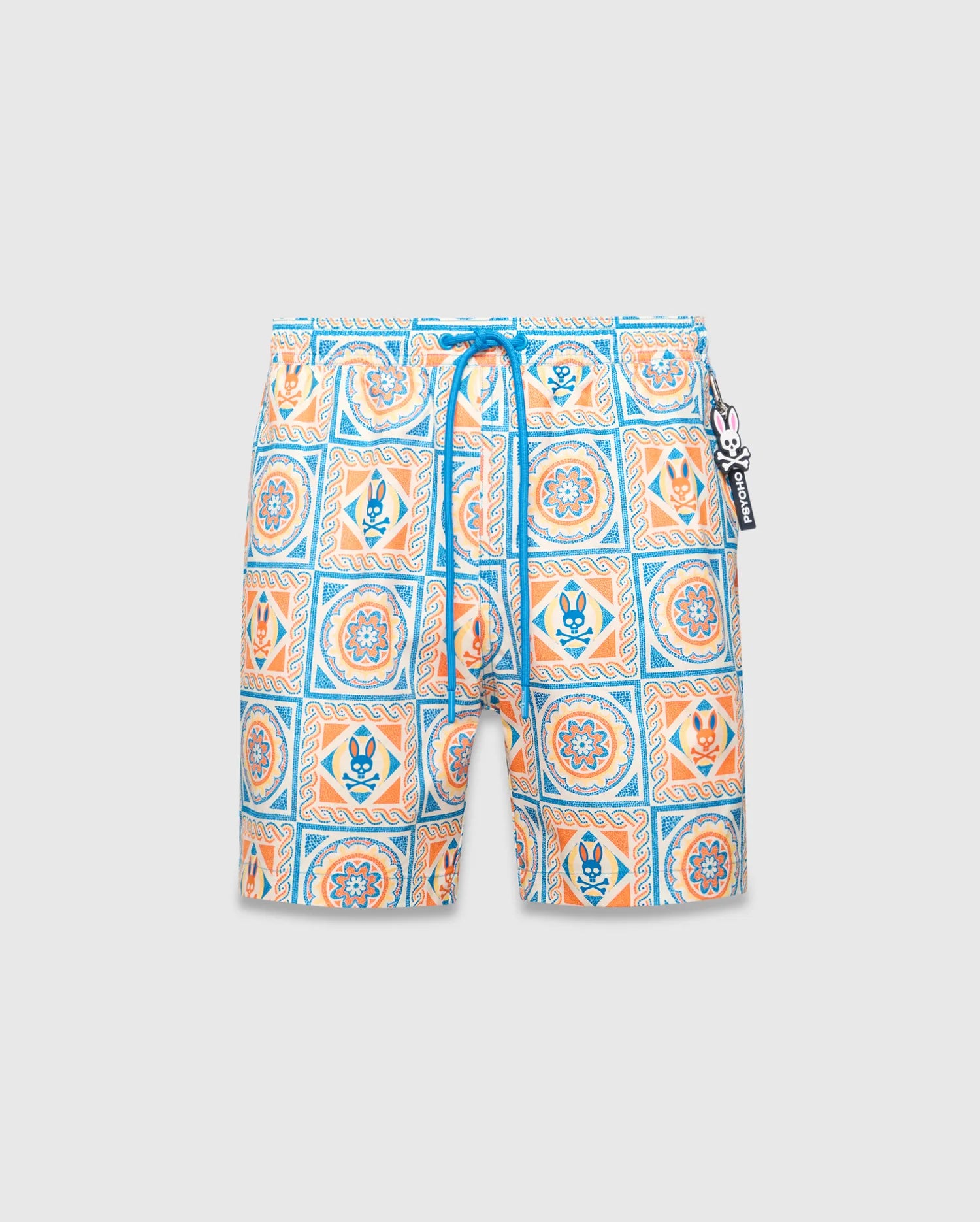 Mens Frank Swim Trunk 6, a classic fit swim trunk featuring an all-over white, blue, orange, and yellow intricate tile pattern with floral motifs and small Psycho Bunny skull logos, finished with a blue drawstring and logo charm.