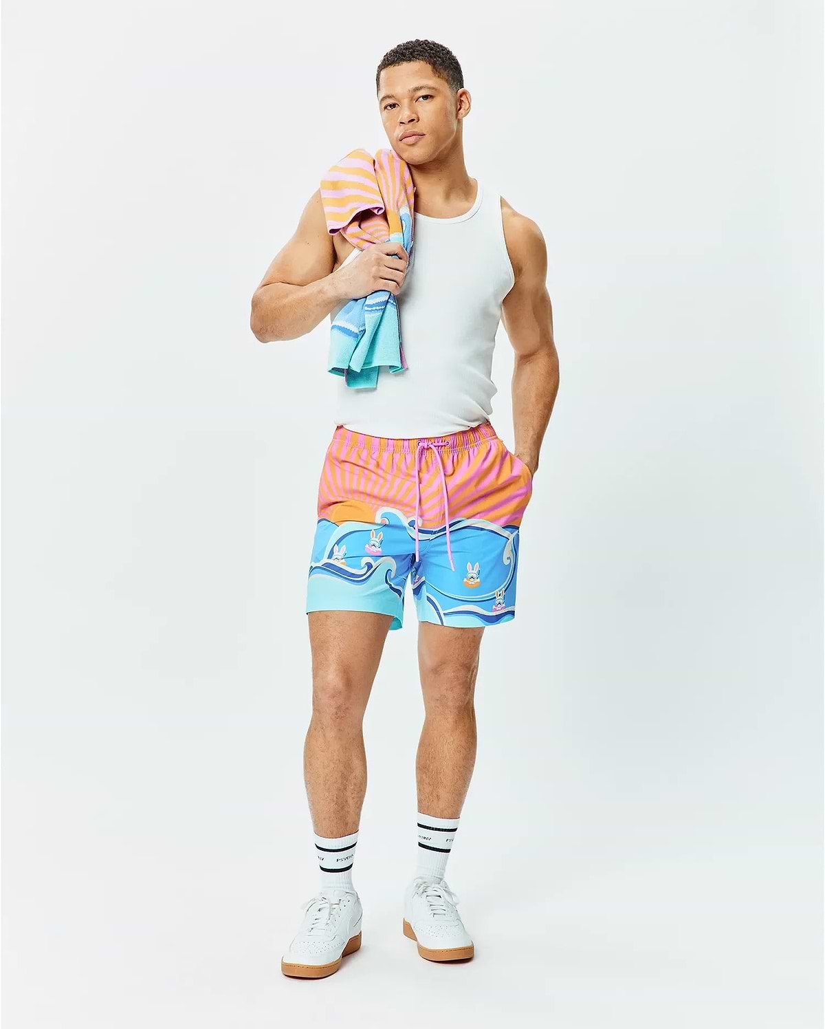 Mens Ray Swim Trunk 6 with a vibrant sunset stripe and ocean wave graphic featuring small Psycho Bunny skull logos, relaxed fit, quick-dry fabric, pink drawstring. (5)