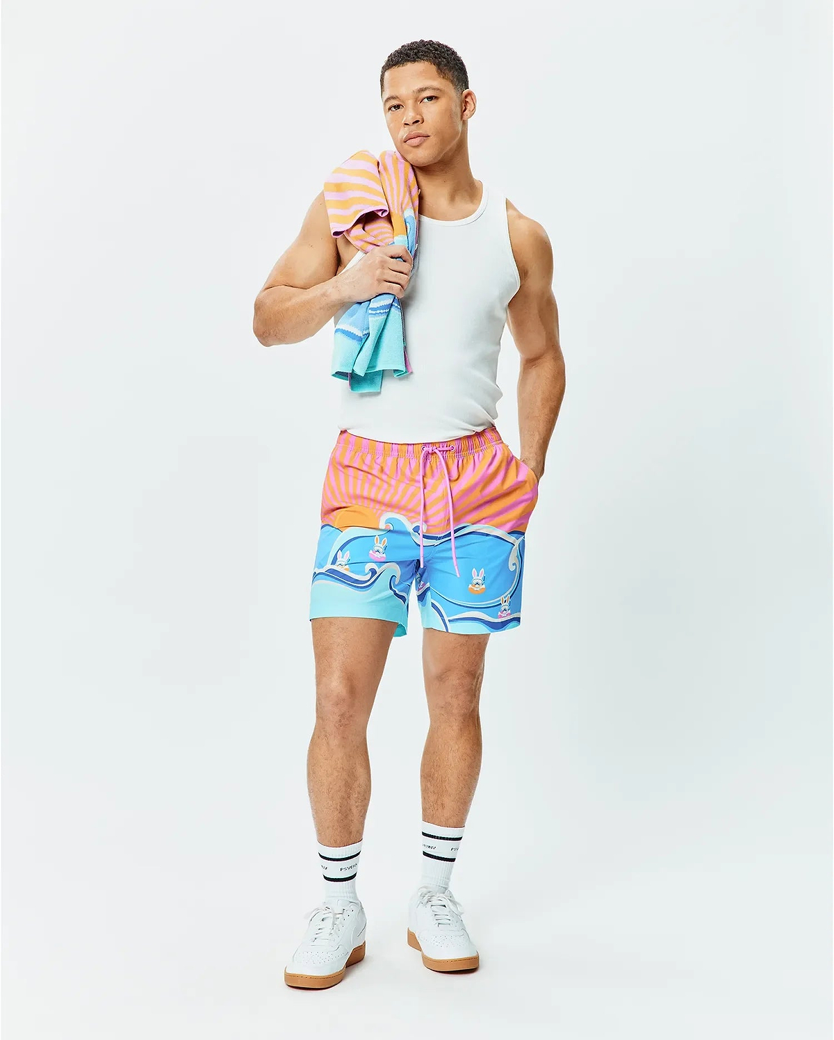 Mens Ray Swim Trunk 6 with a vibrant sunset stripe and ocean wave graphic featuring small Psycho Bunny skull logos, relaxed fit, quick-dry fabric, pink drawstring. (5)