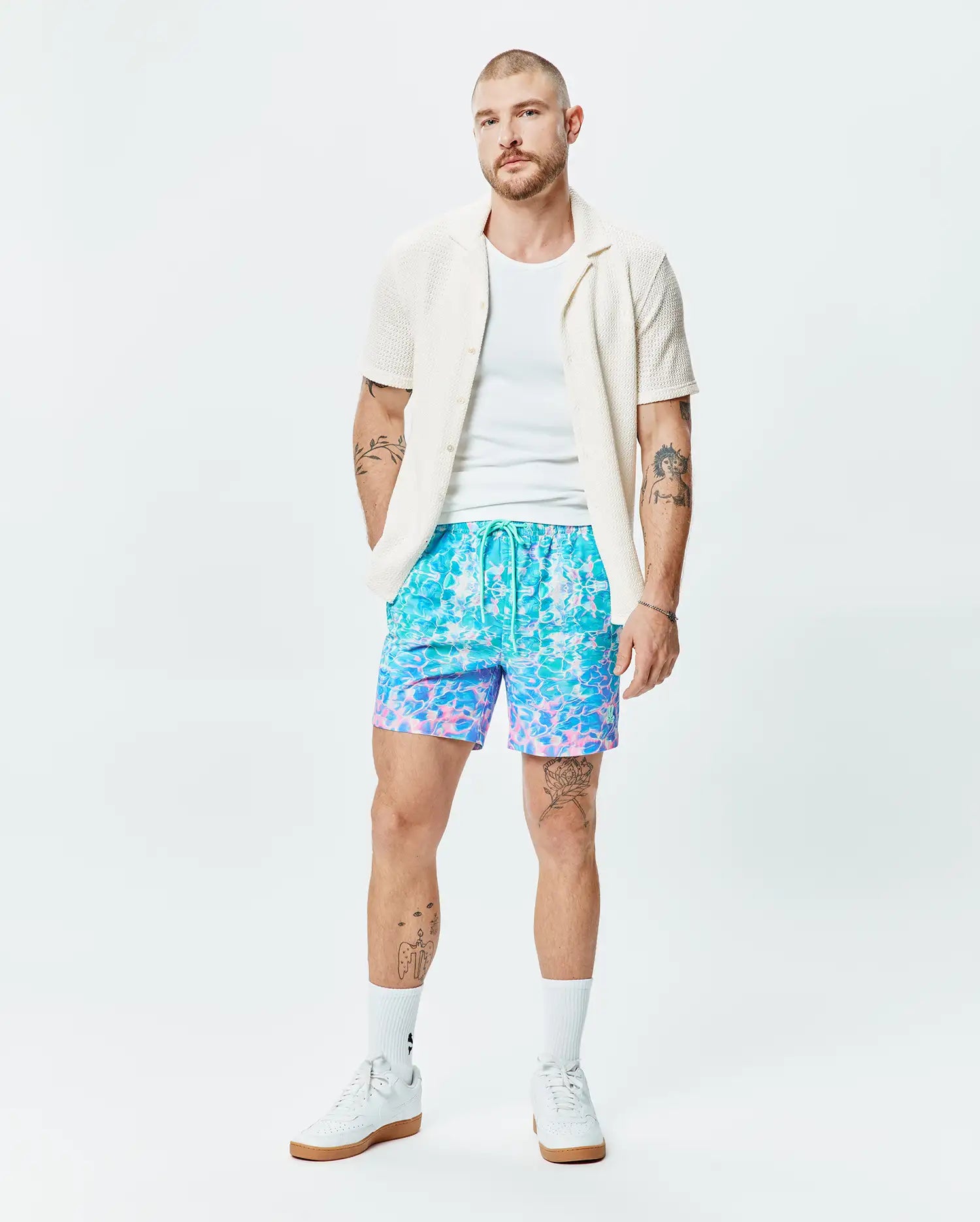 Mens Dayton Swim Trunk 6, a classic fit swim trunk in bold, vibrant blue, turquoise, and pink abstract water ripple print, crafted from smooth quick-dry fabric. (4)