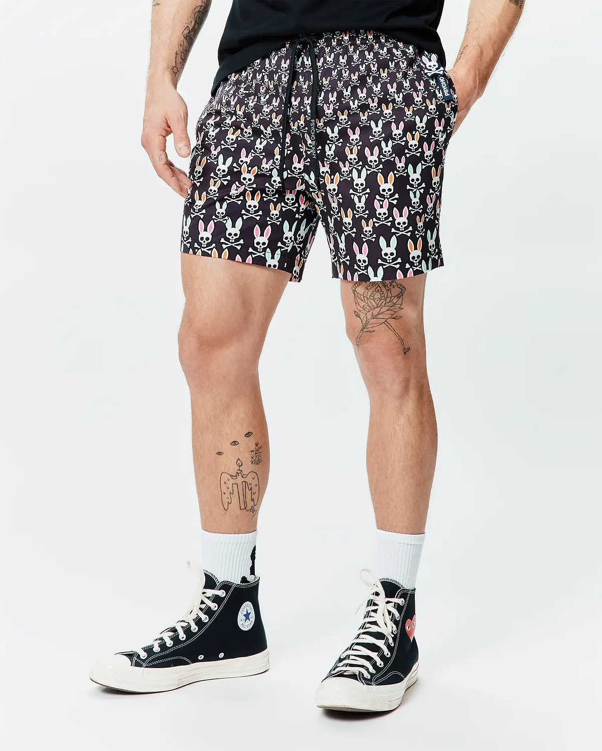 Mens Byron Swim Trunk 6, black with an all-over vibrant multi-color Psycho Bunny skull and crossbones print, featuring a classic fit, smooth quick-dry fabric, and a small Psycho Bunny logo tag. (1)