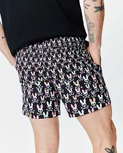 Black Mens Byron Swim Trunk 6 with a vibrant all-over pattern of white bunny skulls, featuring pink, orange, and mint green ears, crossed with white bones, in a relaxed fit. (2)