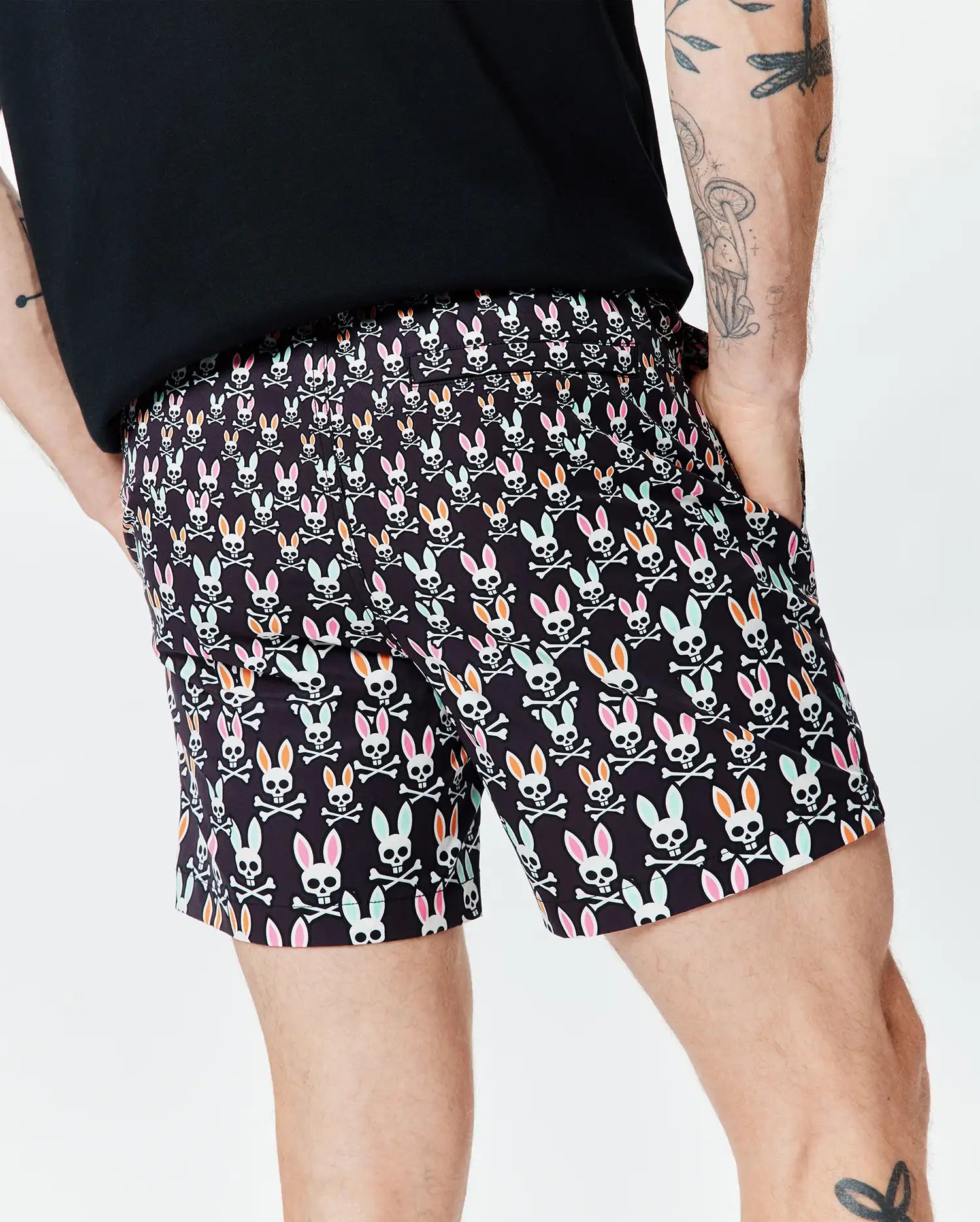 Black Mens Byron Swim Trunk 6 with a vibrant all-over pattern of white bunny skulls, featuring pink, orange, and mint green ears, crossed with white bones, in a relaxed fit. (2)