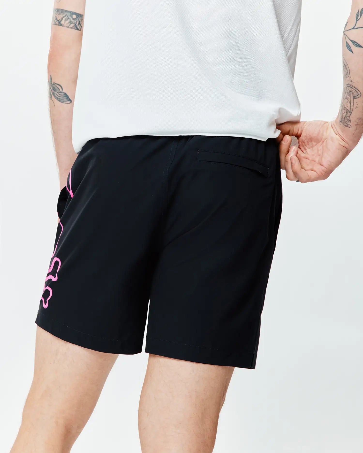 Mens Duncan Bunny Print Swim Trunk in black, featuring a large pink Psycho Bunny logo graphic on the left leg, relaxed fit, smooth quick-dry fabric, and a back pocket.
