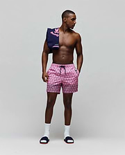 Mens Keon Swim Trunk, pink with an all-over black Psycho Bunny skull logo print, black drawstring, waistband, white Psycho Bunny logo on left pocket, and a patterned hem, in a classic fit. (4)