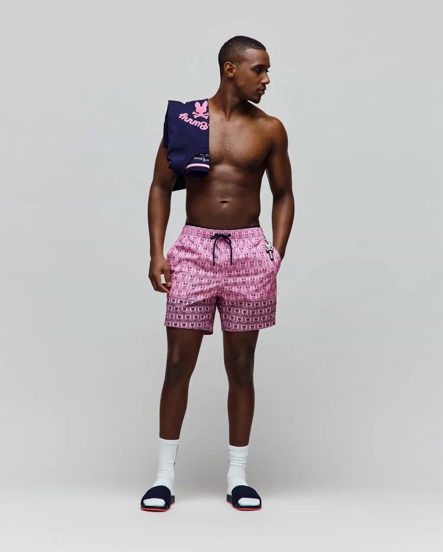 Mens Keon Swim Trunk, pink with an all-over black Psycho Bunny skull logo print, black drawstring, waistband, white Psycho Bunny logo on left pocket, and a patterned hem, in a classic fit. (4)