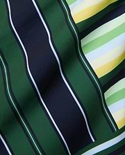 Mens Drew All Over Print Swim Trunk featuring a bold multi-directional stripe pattern in dark green, navy, white, light green, yellow, and light blue on smooth fabric. (6)