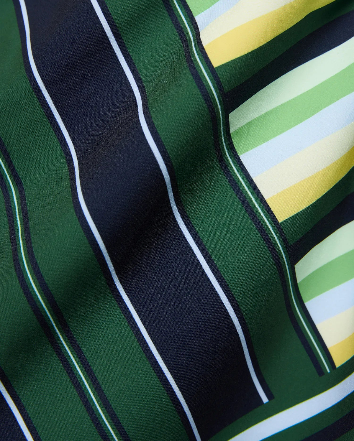 Mens Drew All Over Print Swim Trunk featuring a bold multi-directional stripe pattern in dark green, navy, white, light green, yellow, and light blue on smooth fabric. (6)