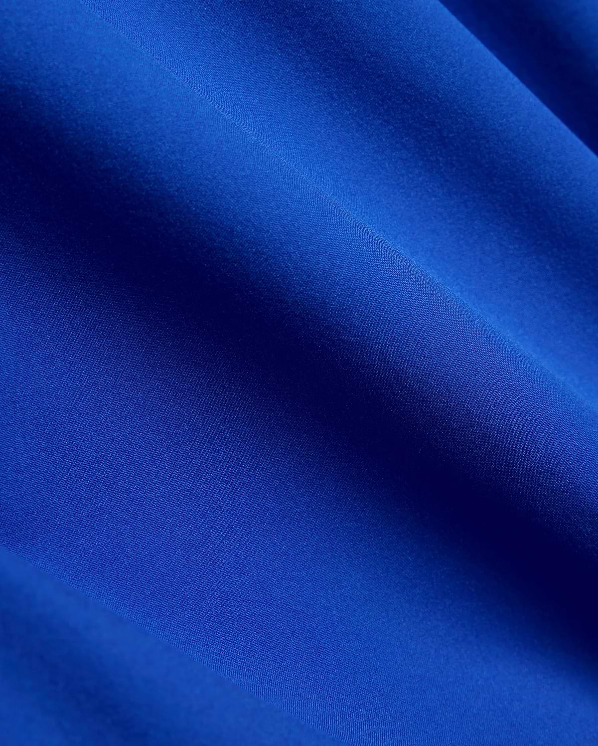 Vibrant royal blue Mens Nathaniel Swim Trunk, featuring a smooth, durable, finely woven fabric with a subtle, quick-drying texture, perfect for active wear. (6)