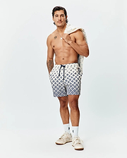 Mens Tobias Swim Trunk in cream with a navy blue geometric pattern, featuring a navy drawstring, small Psycho Bunny skull logo on the left leg, and a branded side tag.