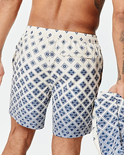 Mens Tobias Swim Trunk in cream with a navy blue all-over geometric pattern featuring the small Psycho Bunny skull logo, classic fit, smooth quick-dry fabric, and a back pocket.