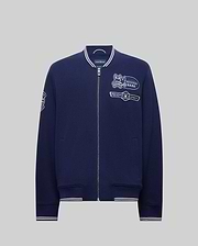 The Psycho Bunny MENS DESMOND PIQUE KNIT BOMBER (MO1100018) is a navy varsity zip-up jacket with white-trimmed collar, cuffs, and hem, embroidered cartoon bunny and "PSYCHO BUNNY" on the chest, plus sleeve designs. (6)