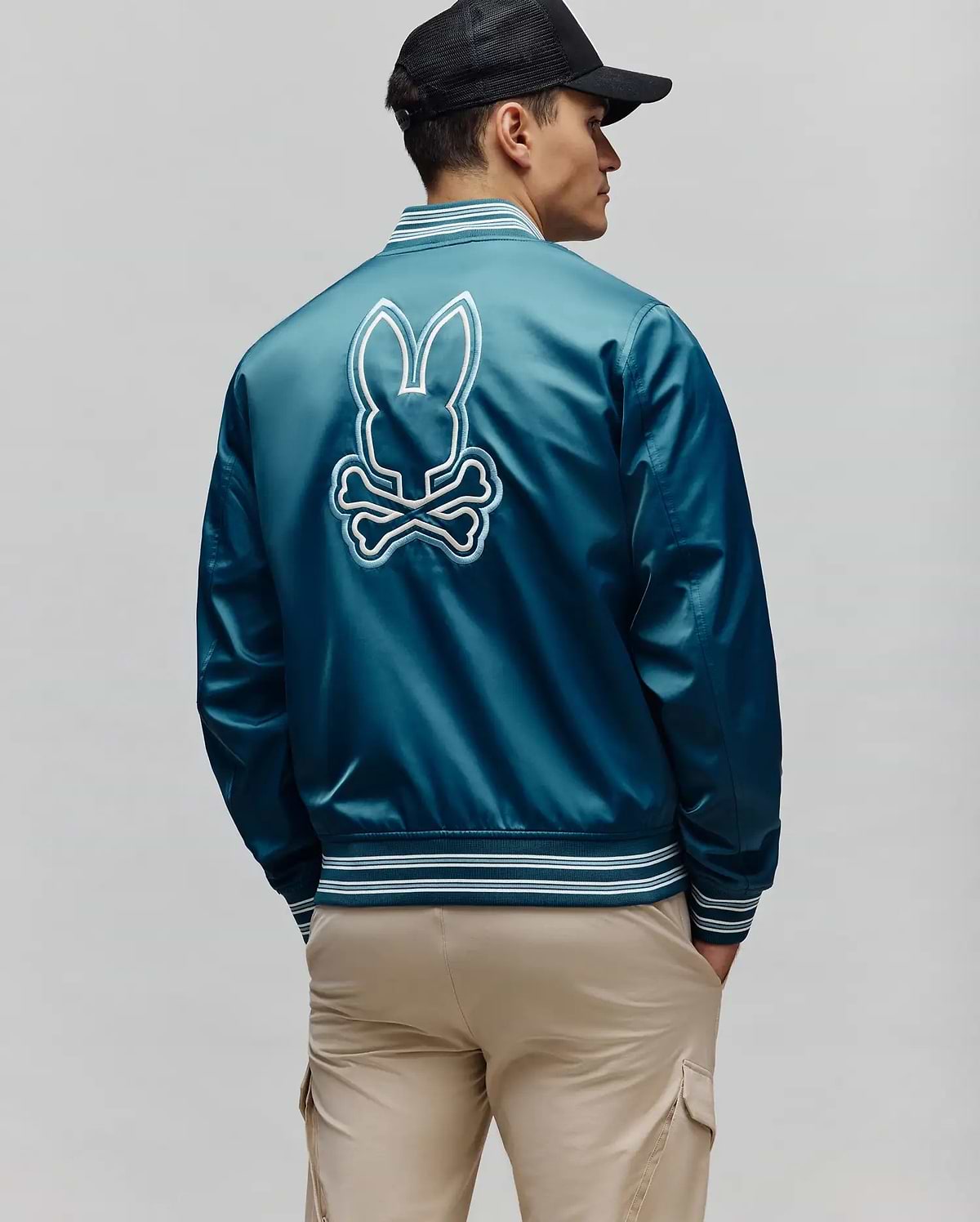 Mens Thomas Satin Bomber in deep teal satin, featuring a large embroidered white and light blue Psycho Bunny skull logo on the back, with striped ribbed cuffs, collar, and hem.