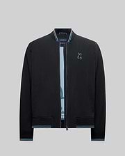 Mens Aldrin Bomber, a black classic fit jacket with light blue striped ribbed collar, cuffs, and hem, featuring an embroidered light blue Psycho Bunny skull logo on the left chest. (7)