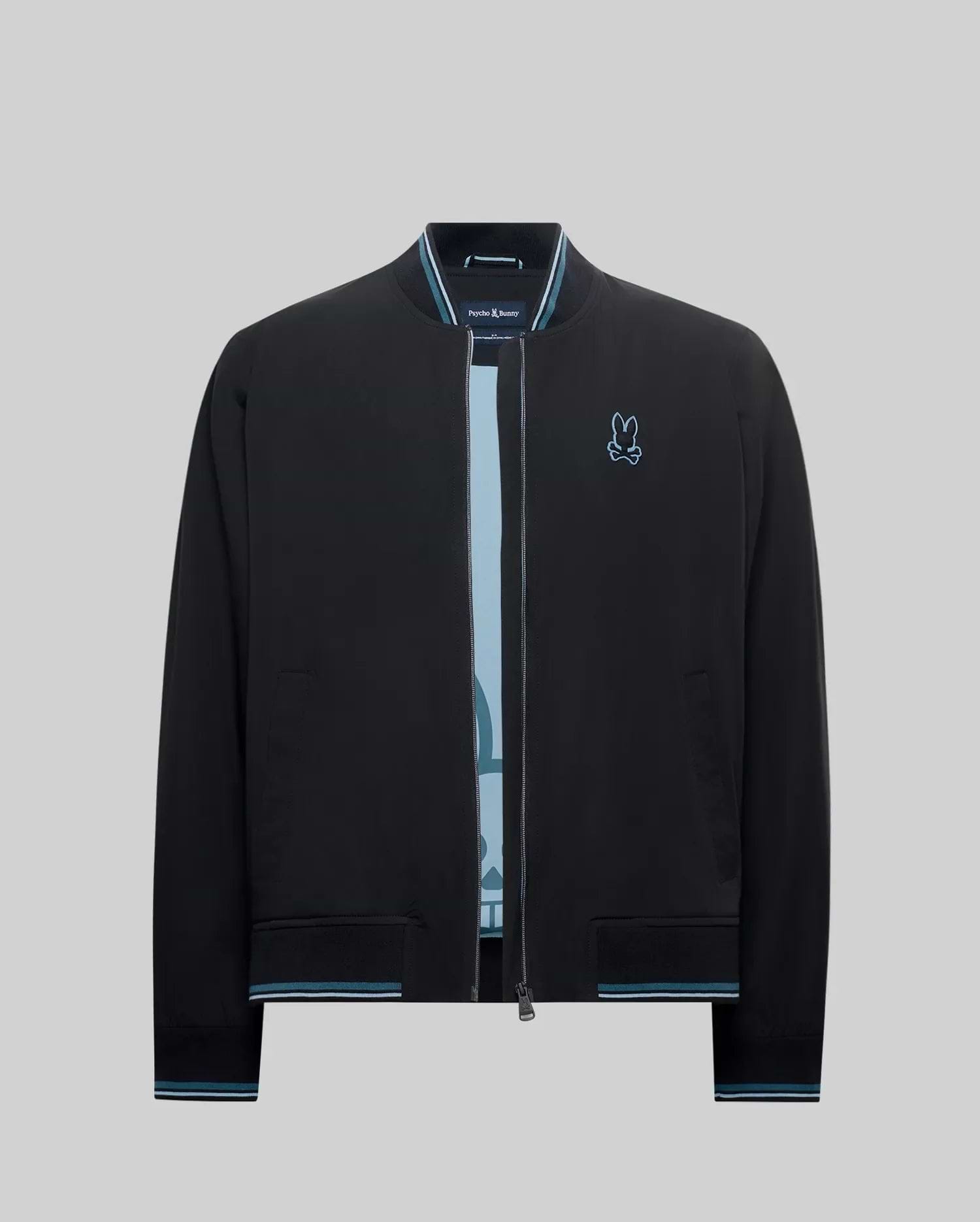 Mens Aldrin Bomber, a black classic fit jacket with light blue striped ribbed collar, cuffs, and hem, featuring an embroidered light blue Psycho Bunny skull logo on the left chest. (7)