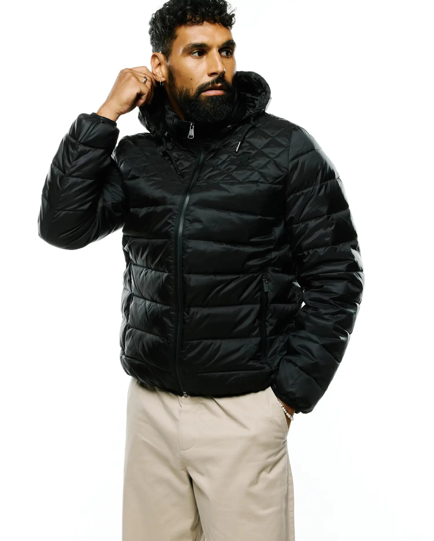 Mens Emerik Hooded Puffer Jacket in black, featuring a classic fit, shiny quilted fabric with diamond pattern on shoulders, horizontal quilting on body, full zip, and a small Psycho Bunny skull logo on the left chest.
