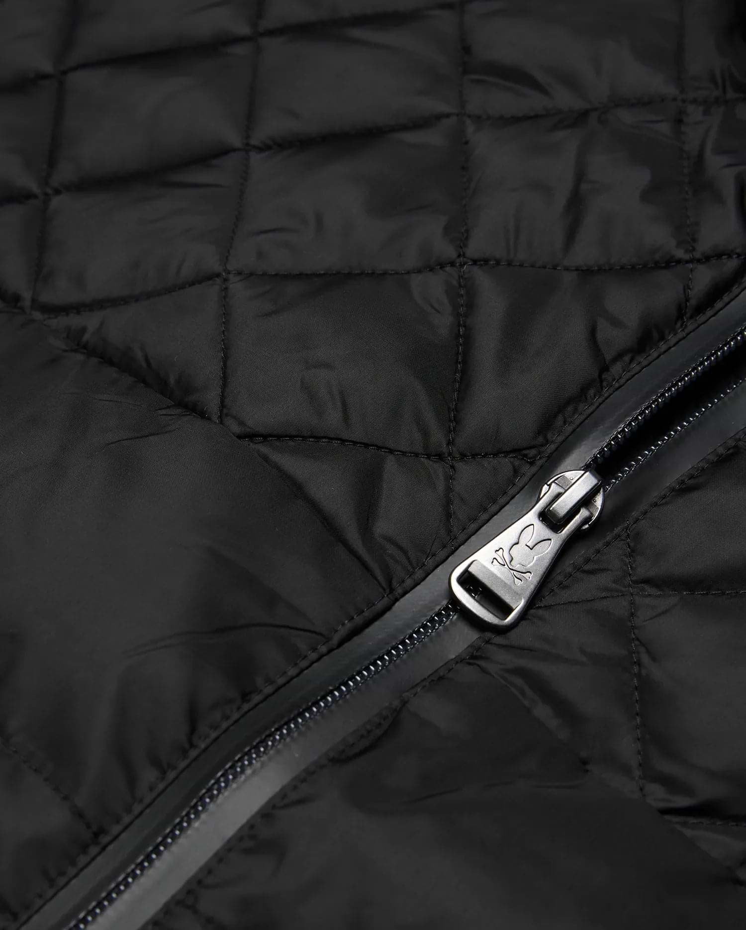 Mens Emerik Puffer Jacket in black quilted nylon, featuring a full-zip closure with a metallic Psycho Bunny skull logo embossed on the zipper pull.