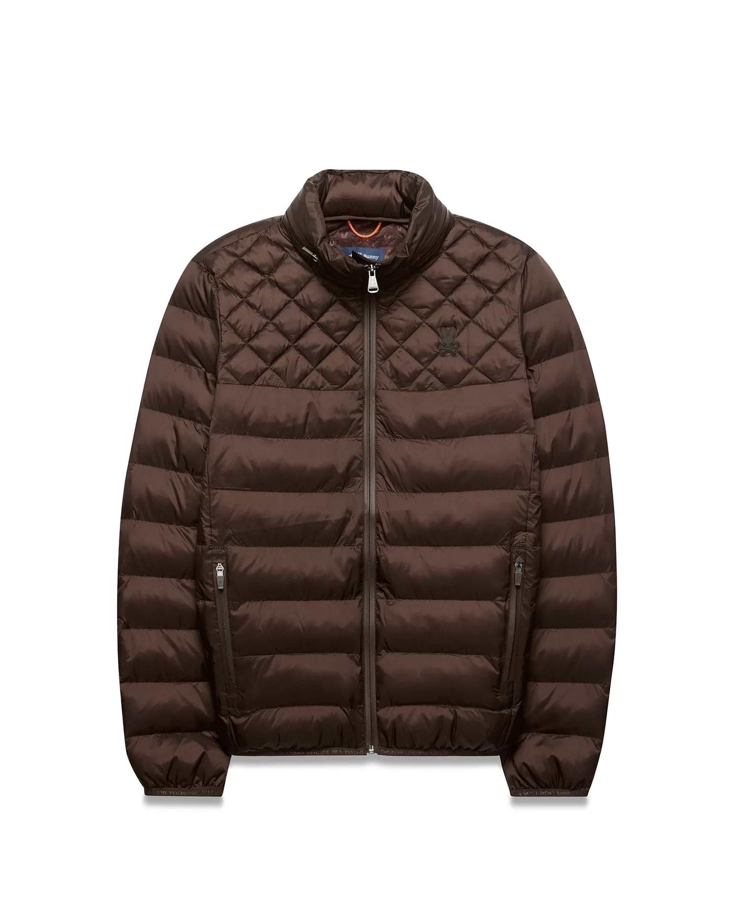 Mens Emerik Puffer Jacket, brown, with diamond quilted shoulders, horizontal body quilting, full zip, stand collar, and small embroidered Psycho Bunny skull logo on left chest; orange inner collar. (5)