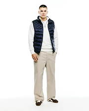 Mens Emerik Quilted Puffer Vest in navy, featuring a diamond quilted pattern, full zip front, stand collar with white lining, and a small Psycho Bunny skull logo on the zipper pull. Classic fit. (6)