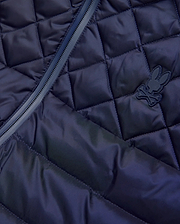 Mens Emerik Puffer Vest in navy, featuring a diamond quilted pattern, full-zip closure with dark trim, and a small, matching navy rubberized Psycho Bunny skull logo on the chest. (8)