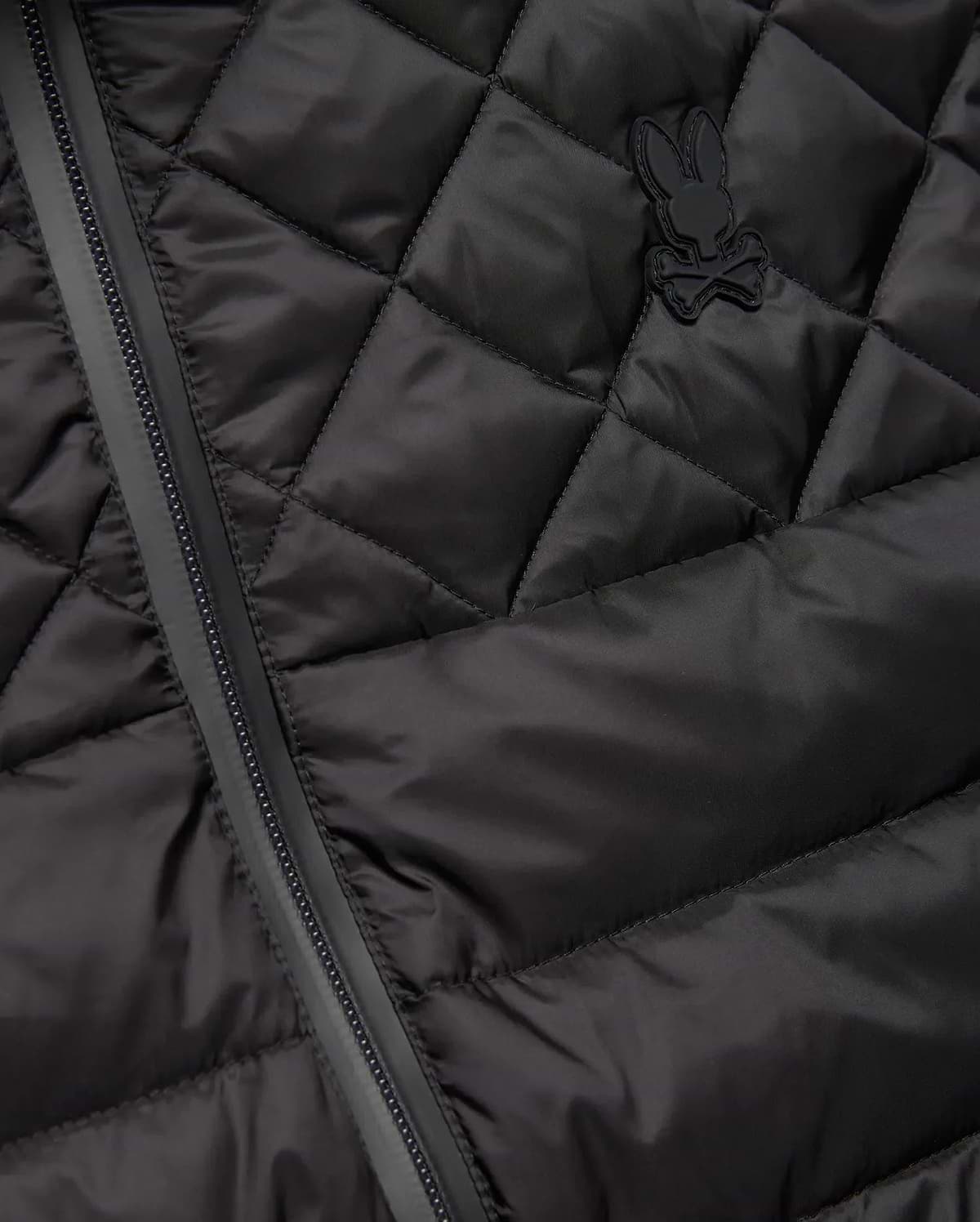 Mens Emerik Puffer Vest in black, featuring a quilted smooth nylon fabric, full-zip closure, and a small, tonal rubberized Psycho Bunny skull logo on the left chest. (6)