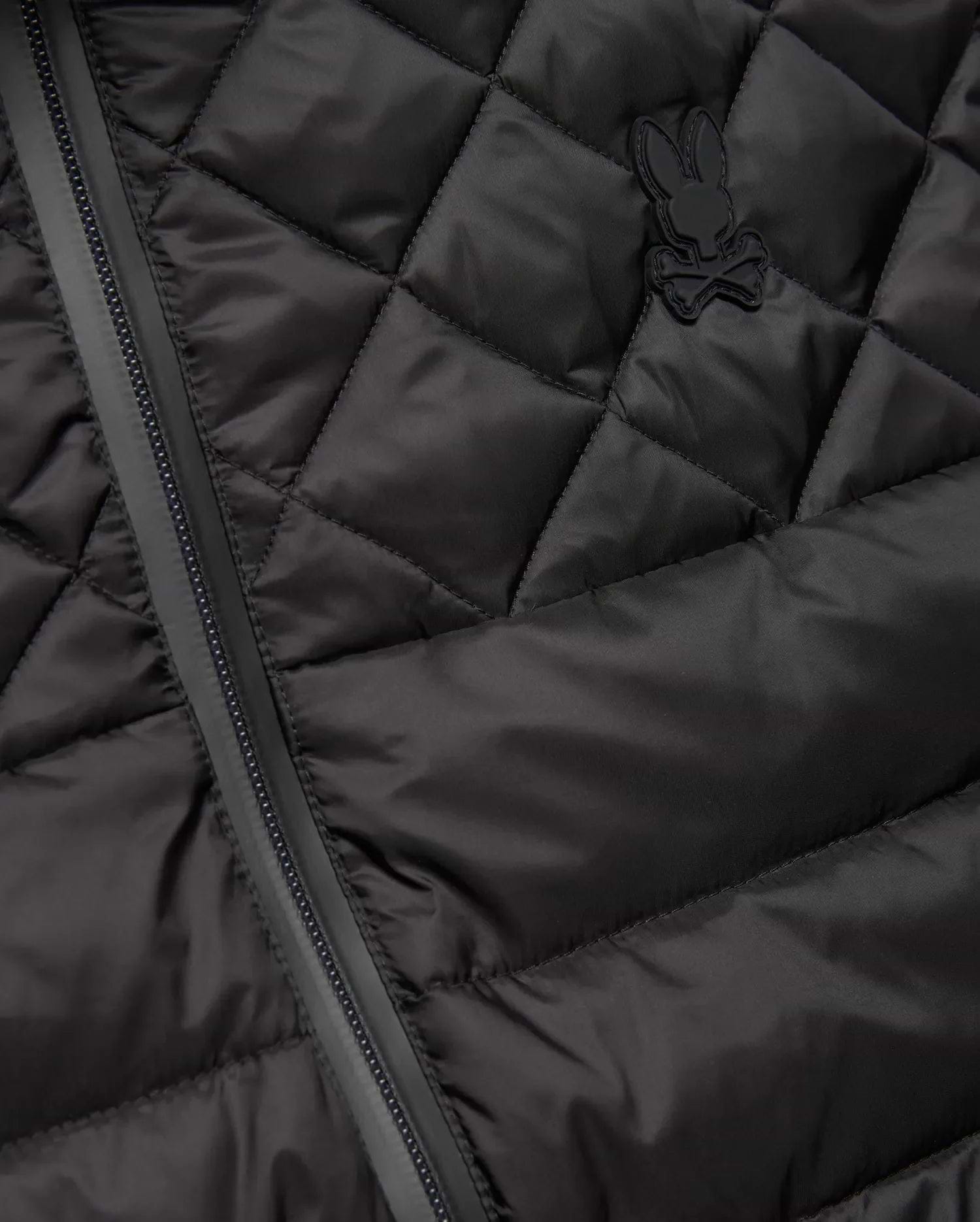 Mens Emerik Puffer Vest in black, featuring a quilted smooth nylon fabric, full-zip closure, and a small, tonal rubberized Psycho Bunny skull logo on the left chest. (6)