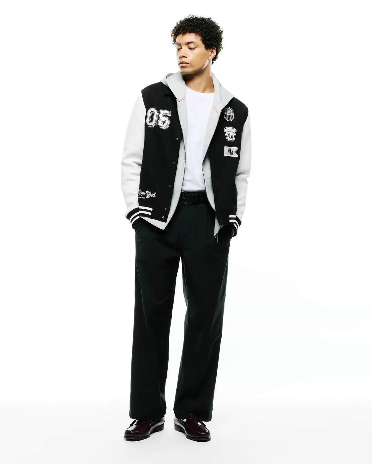 Mens Reilly Knit Coach Jacket: Black and white varsity style jacket with a layered grey hood, featuring a large 05 patch, embroidered Psycho Bunny skull, and New York script. (4)