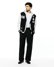 Mens Reilly Knit Coach Jacket: Black and white varsity style jacket with a layered grey hood, featuring a large 05 patch, embroidered Psycho Bunny skull, and New York script. (4)