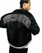 Black Mens Nathaniel Satin Coach Jacket, a relaxed fit, smooth satin jacket with a large white outlined PSYCHO BUNNY text logo across the upper back and a ribbed hem with white double stripes. (1)