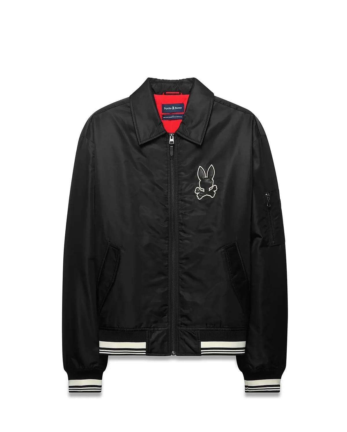 Mens Nathaniel Satin Coach Jacket, black with red lining, featuring a large white embroidered Psycho Bunny skull logo on the chest, white striped ribbed cuffs and hem, and a zippered sleeve pocket. (5)