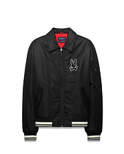 Mens Nathaniel Satin Coach Jacket, black with red lining, featuring a large white embroidered Psycho Bunny skull logo on the chest, white striped ribbed cuffs and hem, and a zippered sleeve pocket. (5)