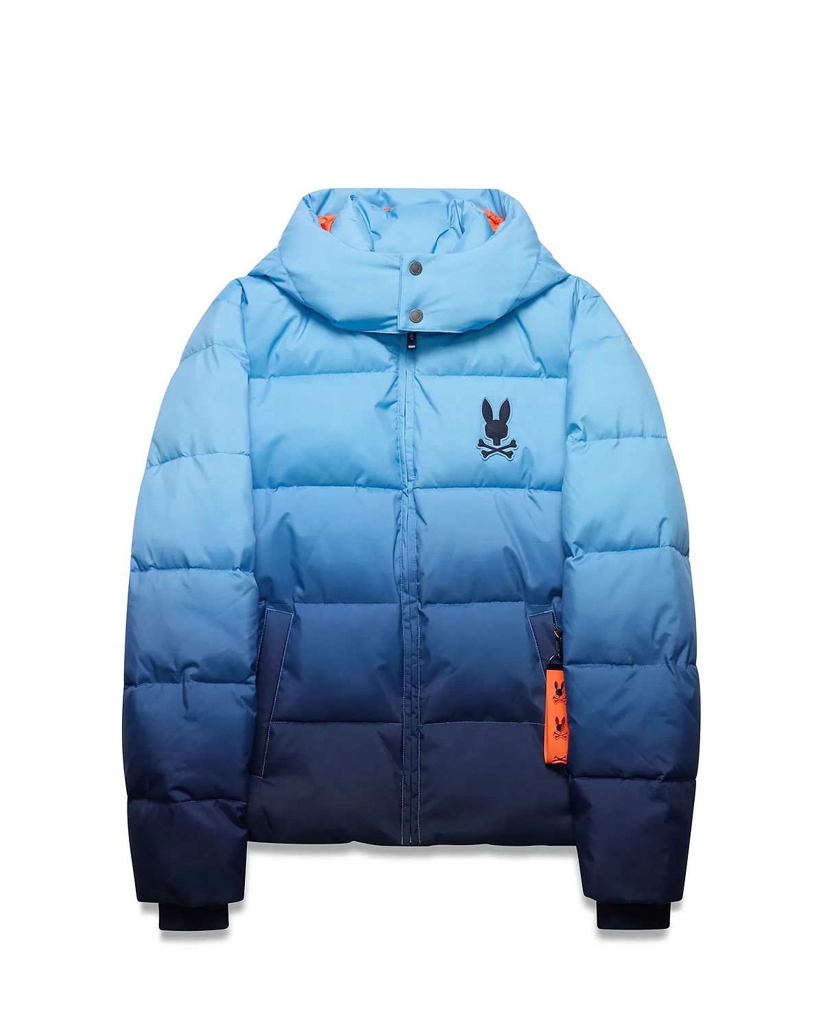 Men's Solan Puffer Jacket, an ombre light blue to navy quilted design with a hooded collar, small embroidered black Psycho Bunny skull logo on the left chest, and an orange branded tag. (5)