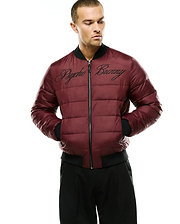 Men's Angus Reversible Bomber in maroon, featuring a padded, classic fit design with black ribbed collar, cuffs, and hem. A large, black embroidered Psycho Bunny script logo spans the chest, complemented by a full-zip front. (1)