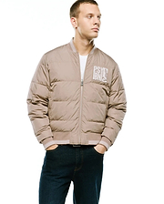 Men's Franco Reversible Bomber, a relaxed fit beige padded bomber jacket with full zip, striped ribbed trim, and a large white embroidered PSYC IBNIS bunny skull logo on the left chest. (4)