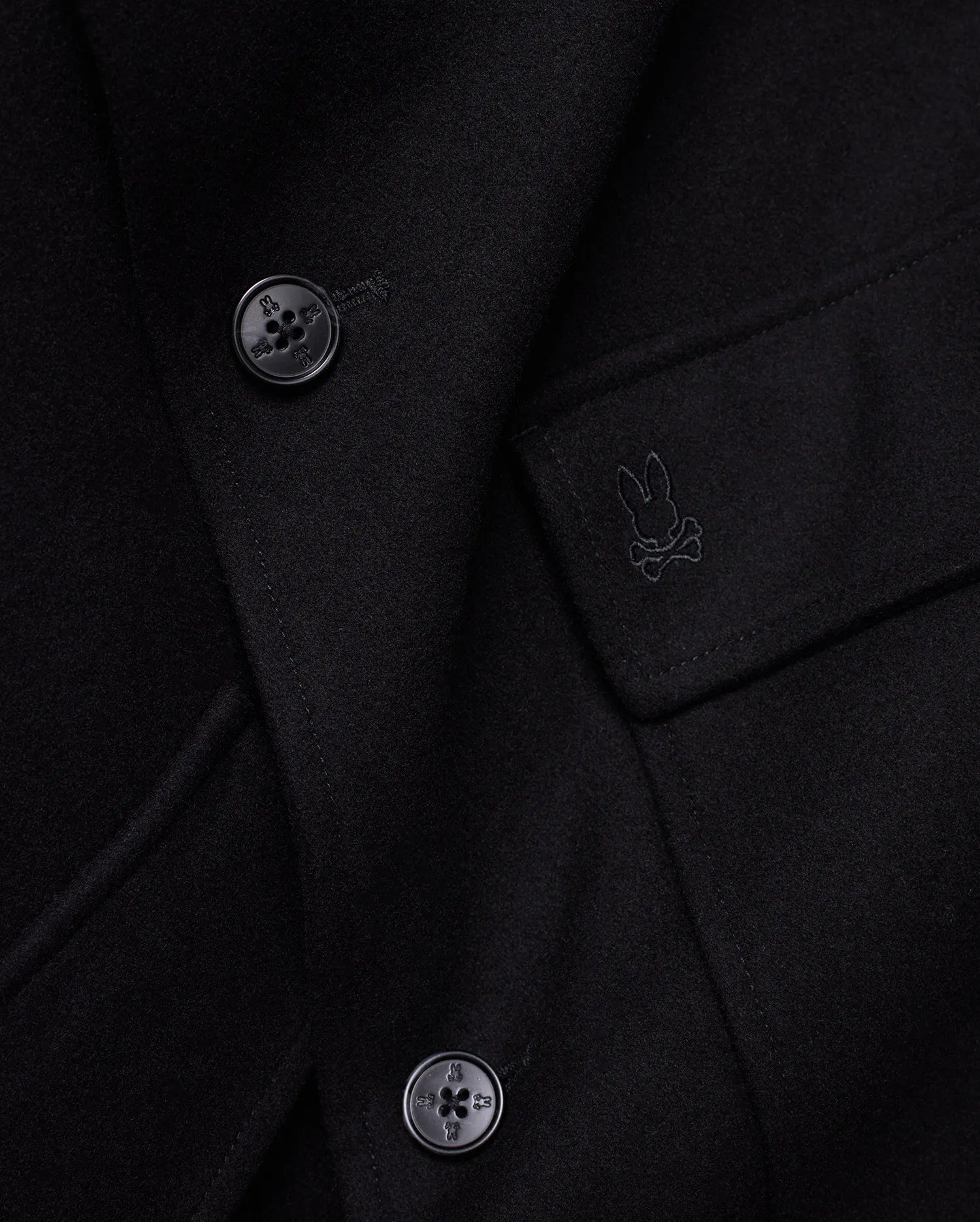 Mens Luther Wool Blend Coat, black, crafted from a smooth wool blend, featuring a tonal embroidered Psycho Bunny skull logo on the chest pocket flap and custom logo buttons.