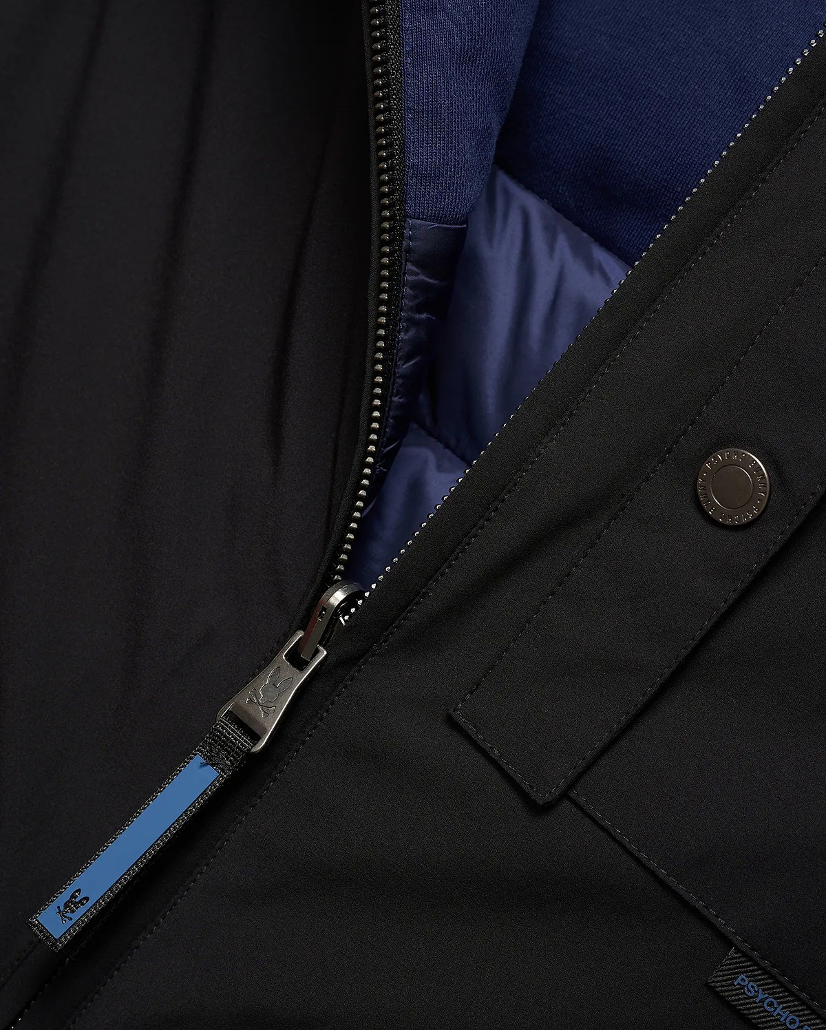 Mens Gordler Reversible Vest, black smooth woven outer, reversible to navy blue quilted interior with ribbed collar. Features a full zip with Psycho Bunny skull logo pull, branded snap, and Psycho Bunny text tag.